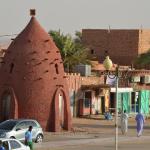Timimoun's characteristic architecture is red mud buildings studded with spikes. Here is a rather odd looking water tank.