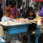 Selling saltenas.