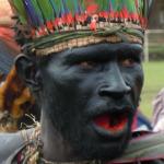 His mouth is stained red from chewing bettlenut.