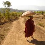 Following the monk through the dusty countryside.