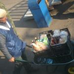 A man selling goods on the train platform at one of the many stops.