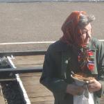 Babushka selling goods on the train platform.